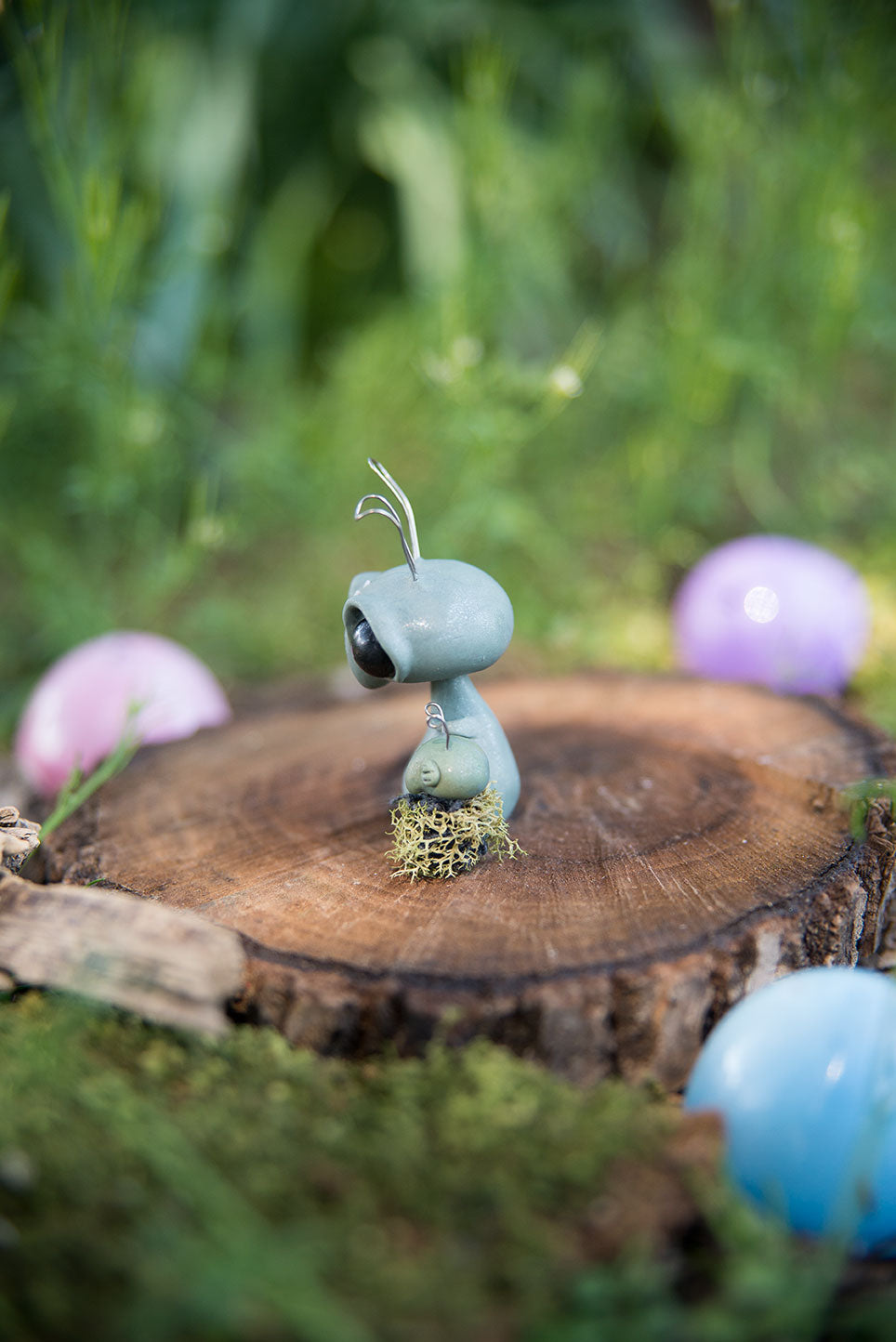 Spring Sprocket Parent with moss swaddled infant #28