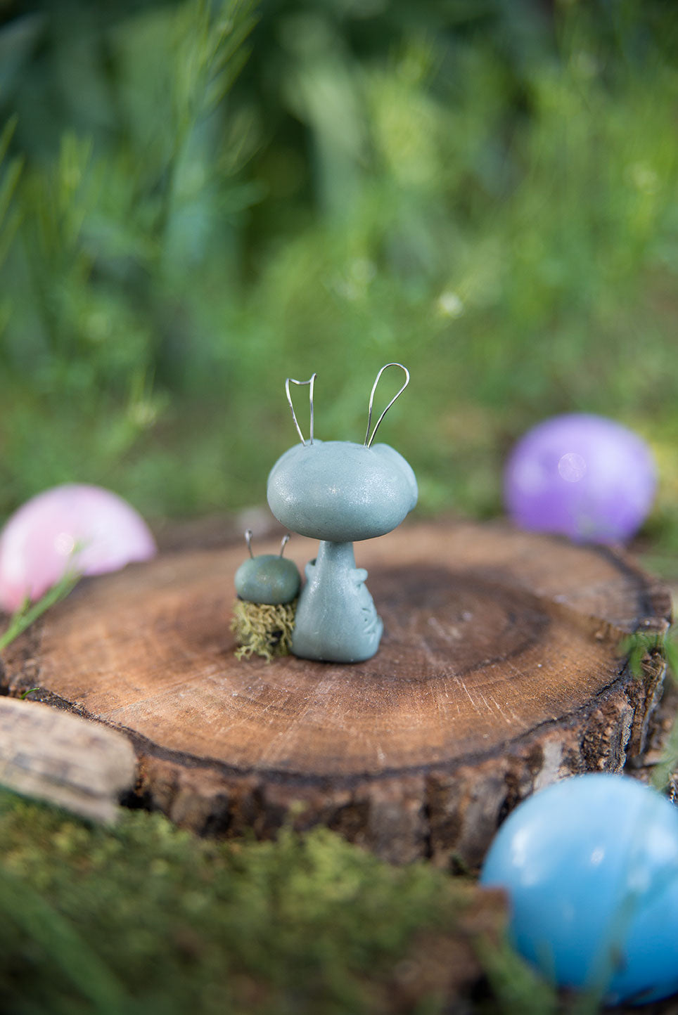 Spring Sprocket Parent with moss swaddled infant #28