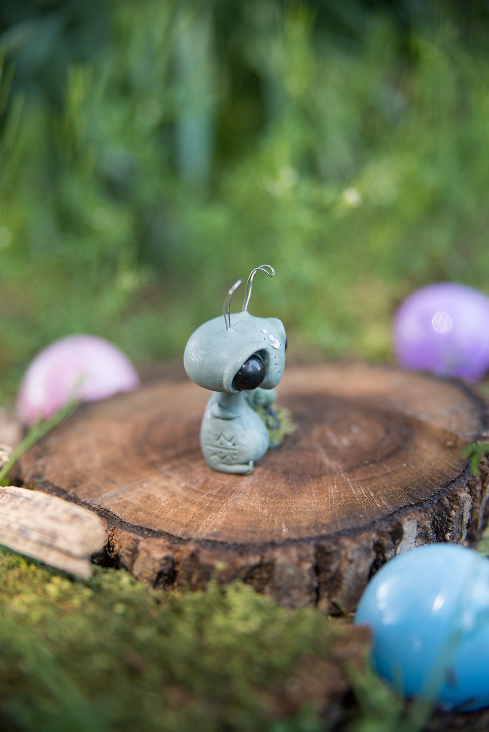 Spring Sprocket Parent with moss swaddled infant #28