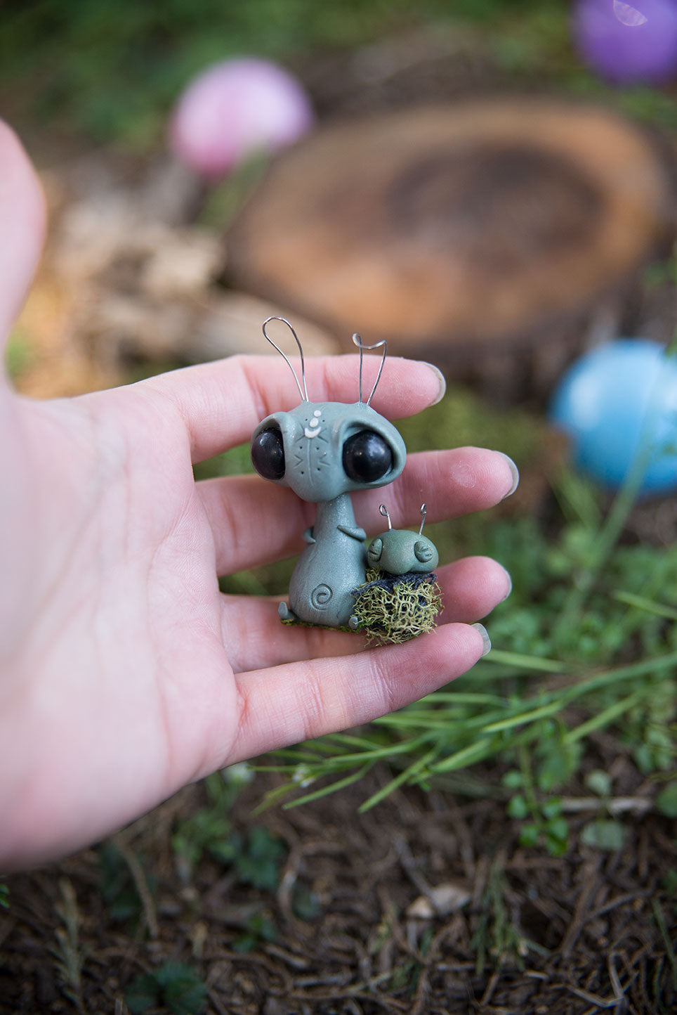 Spring Sprocket Parent with moss swaddled infant #28
