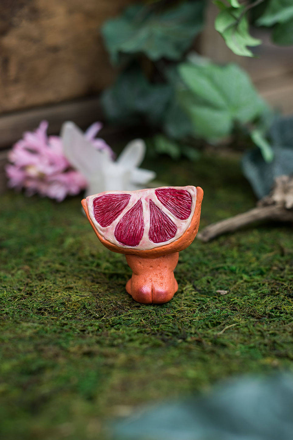 Back View of Blood Orange Mish Tush - handmade polymer clay blood orange creature holding tumbled adventurine