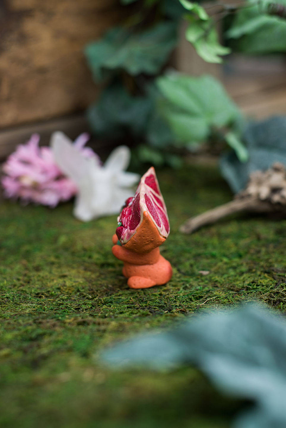 Left-Side View of Blood Orange Mish - handmade polymer clay blood orange creature holding tumbled adventurine