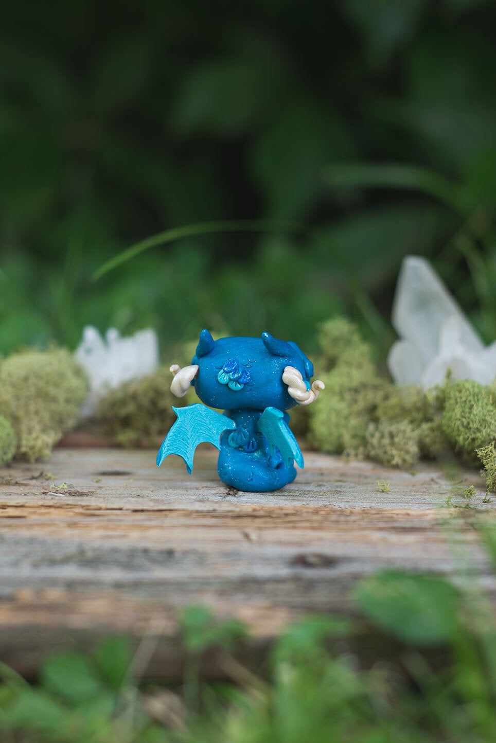 Back View of Blue Dragon Mish Tail & Wings - handmade polymer clay dragon creature with tail and wings, holding aquamarine crystal
