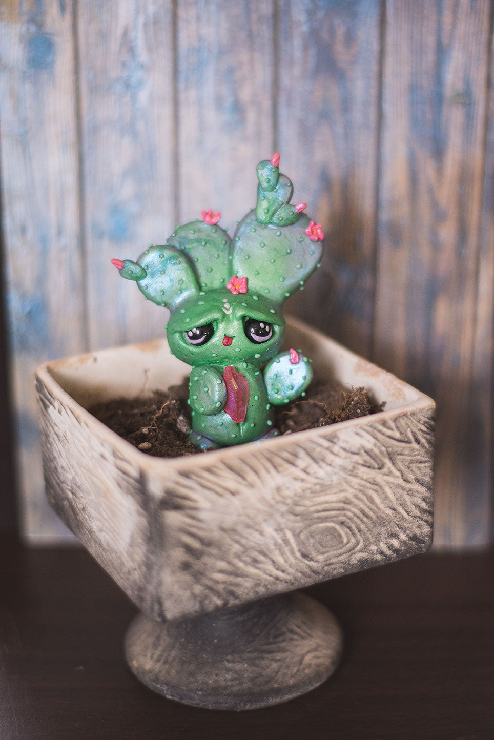 Custom hand sculpted polymer clay green cactus with pink flowers mish in pot holding pink aura quartz