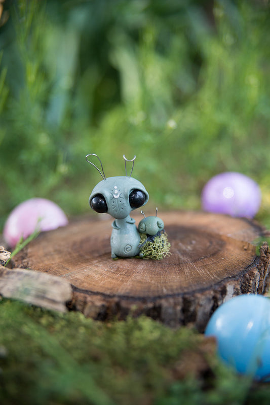Spring Sprocket Parent with moss swaddled infant #28