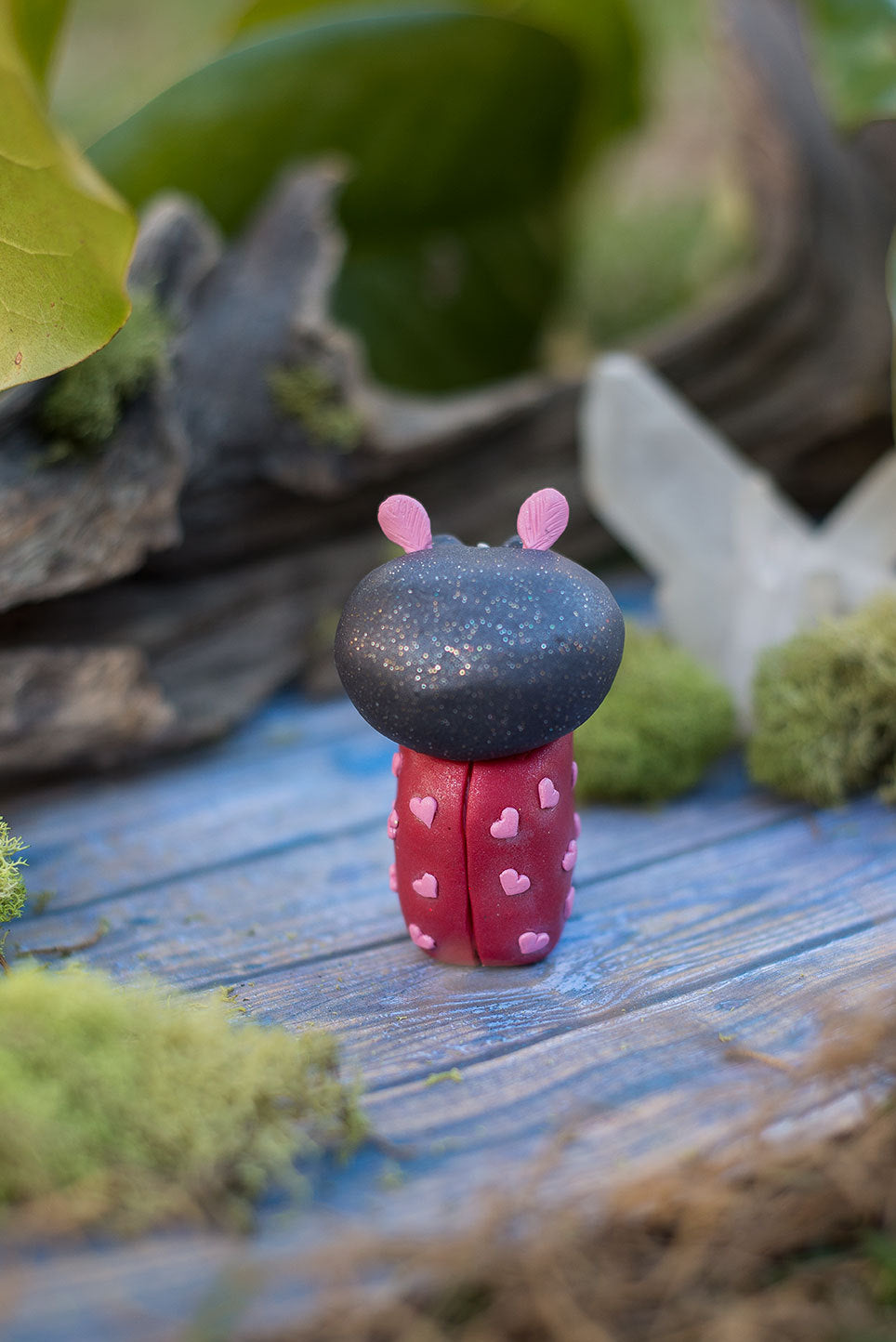 Back view of Amoura the love bug Mish - hand sculpted red and black ladybug polymer clay creature with pink hearts and rose quartz
